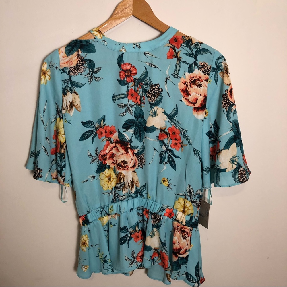 Belle Sky Floral blouse bluish turquoise with multicolored flowers.
